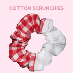A scrunchie which is made up of half red gingham (large check) and white fabric. Slog says 'Cotton scrunchies.'