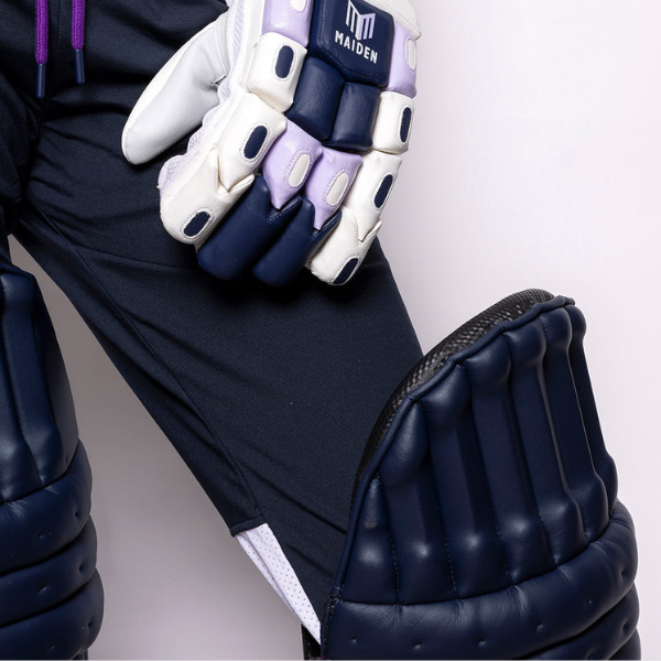 Maiden blue cricket pads with glove on person