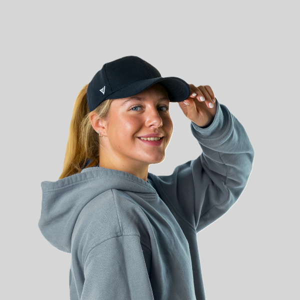 Person wearing The Magni-Strip® Lifestyle Cap Navy and grey hoodie