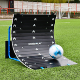 Football skills ramp trainer equipment with a ball on a grass field