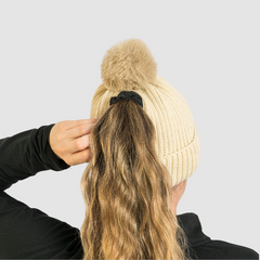 Person wearing Woman wearing Magni-Strip® Bobble Hat Beige adjusting their hair