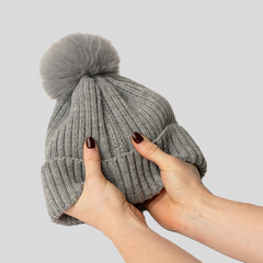 Magni-Strip® Bobble Hat Grey held by hands