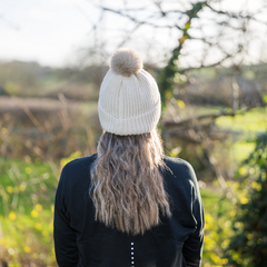 Woman wearing Magni-Strip® Bobble Hat Beige outdoors