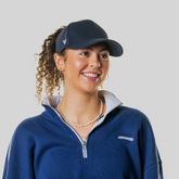 Woman wearing a Magni-Strip® Lifestyle Cap Navy and navy sweater