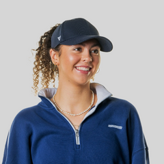 Woman wearing a Magni-Strip® Lifestyle Cap Navy and navy sweater