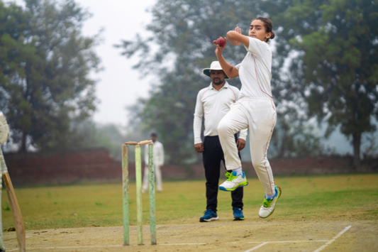 Girl playing cricket