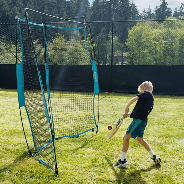 Boy batting into cricket backfire net