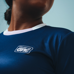 The white logo of Eleven as One on the long sleeved navy blue training top. 