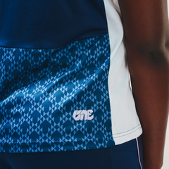 Showing the finer details of the Eleven as One blue training top including the patterned panel and Eleven as One logo. 