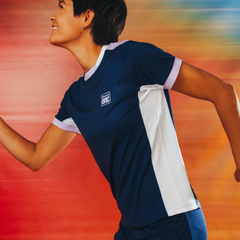A football player in profile and in motion, showing the white side panels and white trim in more detail. 