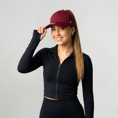 Woman wearing Versatail Berry Red cap