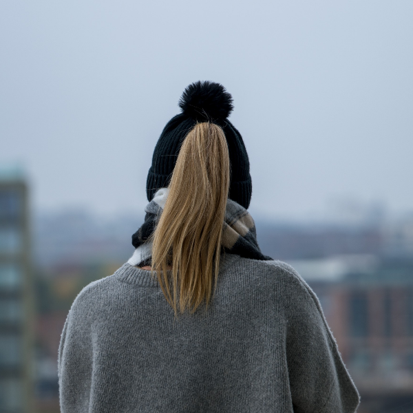 Person wearing The Magni-Strip® Bobble Hat Black with grey coat
