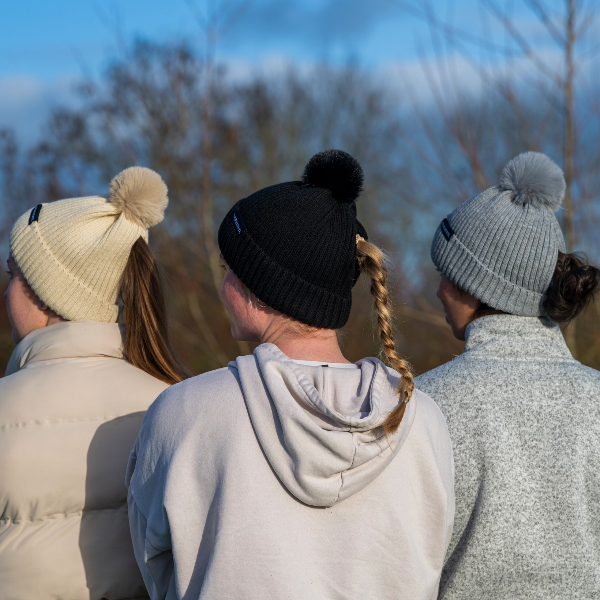 Three people wearing The Magni-Strip® Bobble Hat Grey, Beige and black