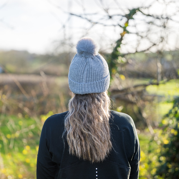 Person wearing a The Magni-Strip® Bobble Hat Grey outdoors