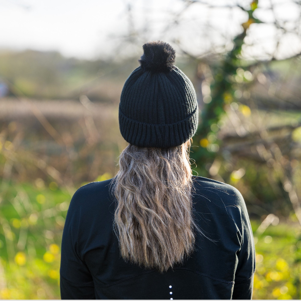 Person wearing The Magni-Strip® Bobble Hat Black outdoors