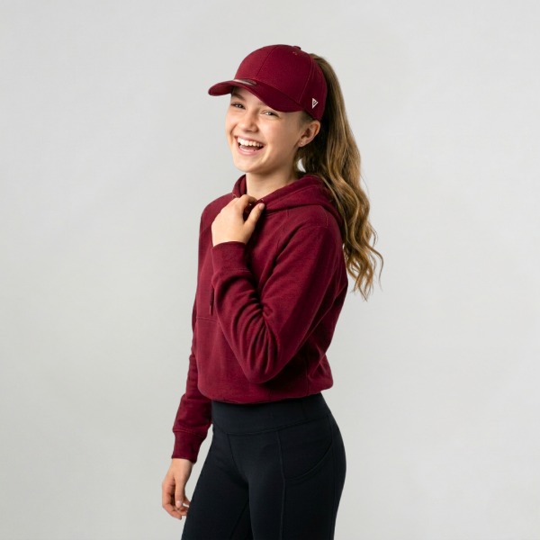 Woman in red jumper wearing Versatail Berry Red cap 